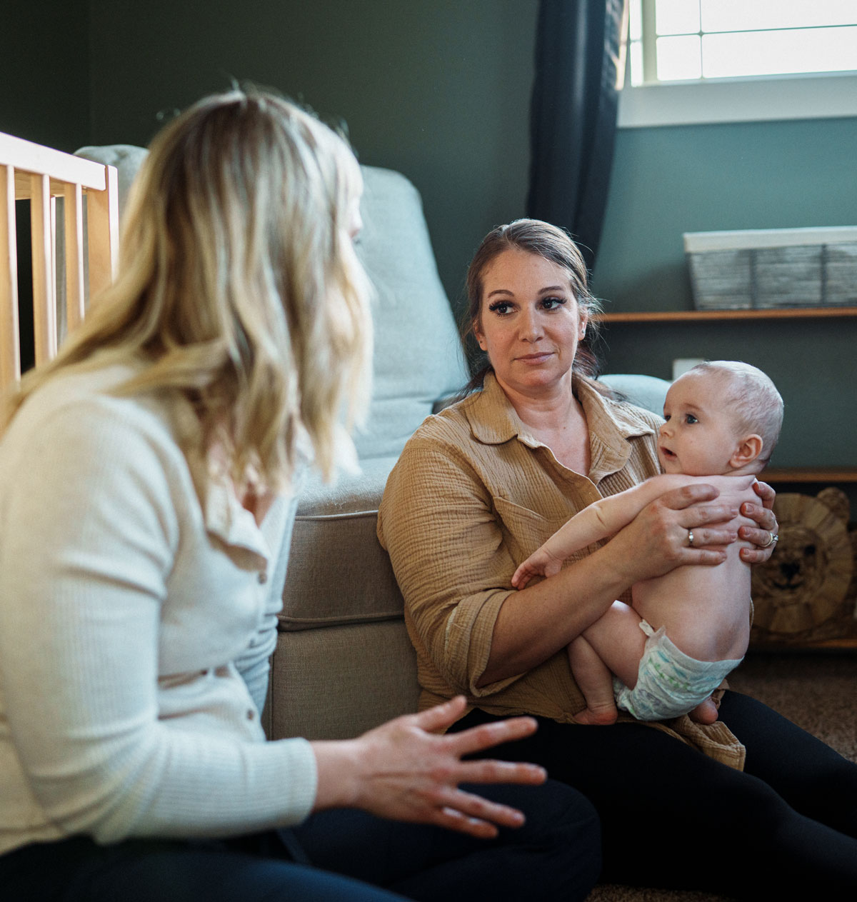 Lactation counselor talks with mother holding baby