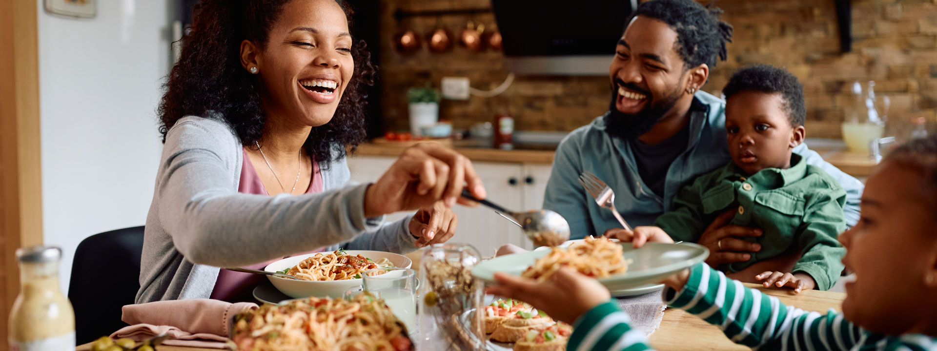 Family happily sharing a meal together in kitchen
