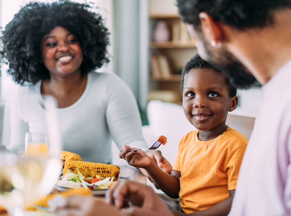 Young boy smiling at the dinner table