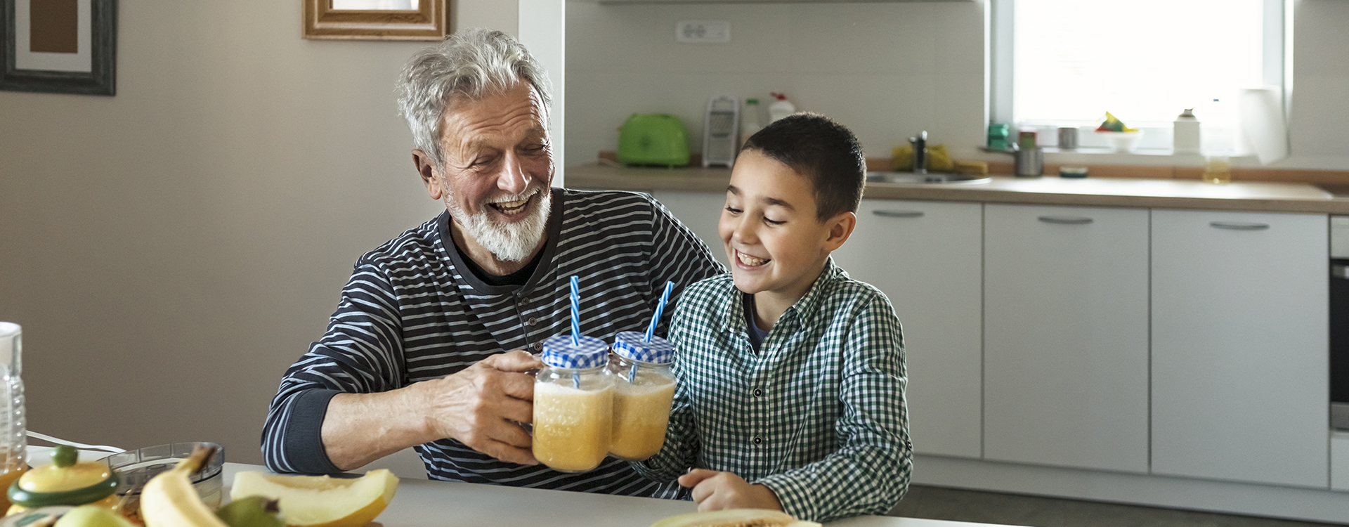 dad and toddler eating veggie smiling banner