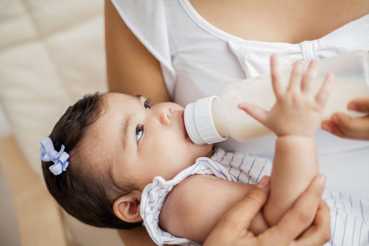 Mom feeding Daughter