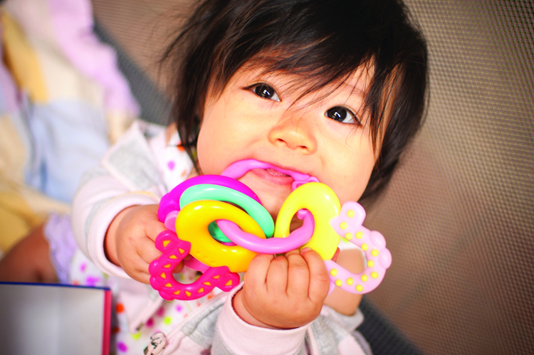 baby chewing on fingers